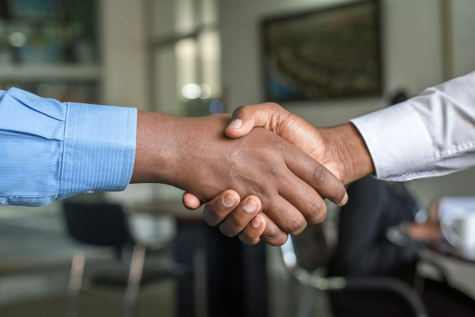 Owner and contractor shaking hands after agreeing on a renovation scope